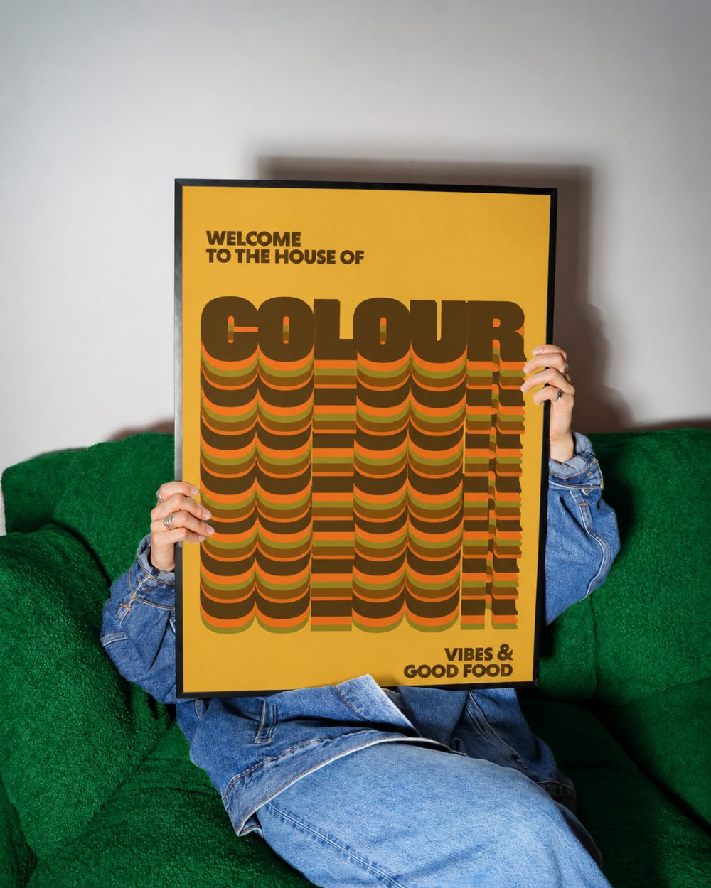 House of Colour print, yellow, framed on a green sofa